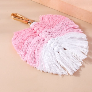 Macro detail of handmade pink and white cotton leaf keychain with golden metal clasp