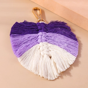 Detailed close-up of handmade Macrame leaf keychain with purple and white cotton fringe