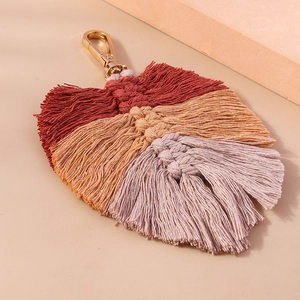 Detailed macro view of handmade woven leaf keychain with gradient bohemian cotton cords