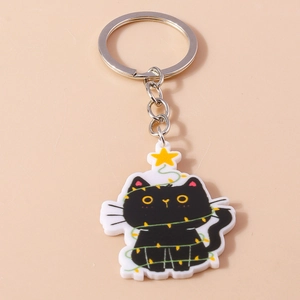 Détail d'un porte-clés chat de Noël avec guirlande lumineuse et pendentif étoile en acrylique