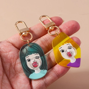 Detail of acrylic girl keychain with creative 3D bubble design and gold metal hook