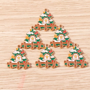 Detail of 6 green enamel Christmas tree alloy charms with golden outlines on wood