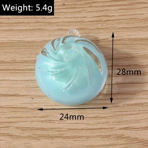 Macro detail of a light blue swirl pendant with glitter and dimensions 28mm x 24mm