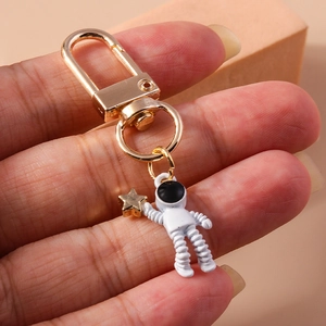 Creative astronaut keychain with white enamel space man and golden star pendant