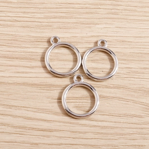 Polished silver circular geometric pendants for DIY jewelry making on wood background