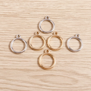 Close-up of gold and silver circular charm pendants for DIY jewelry making accessories