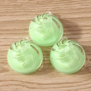 Detail view of light green translucent resin vortex pendants with smooth spiral texture