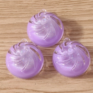Close-up of purple resin candy charms with glitter and swirl texture for DIY jewelry
