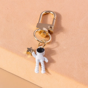 Detail of creative astronaut keychain with golden star charm and U-shaped hook