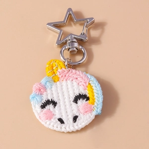Close-up of knit animal keychain featuring star-shaped clasp and pink blue braids