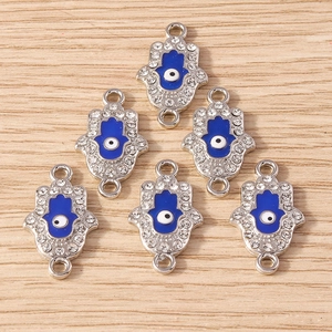 Detail of silver Hamsa Hand and Evil Eye charms with rhinestones for DIY jewelry