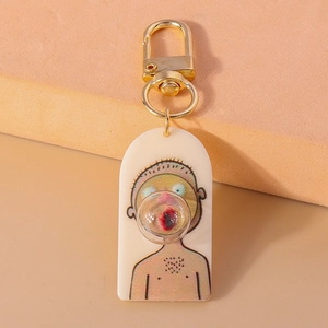 Detailed close-up of acrylic boy charm with a 3D bubble and golden metal clasp keychain