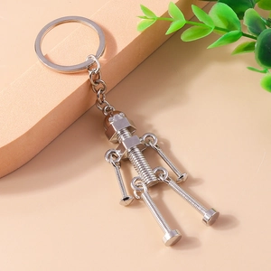 Handmade industrial robot keychain crafted from metal screws and nuts on beige background