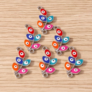 Detail of leaf-shaped evil eye jewelry connectors in diverse enamel colors for DIY crafts