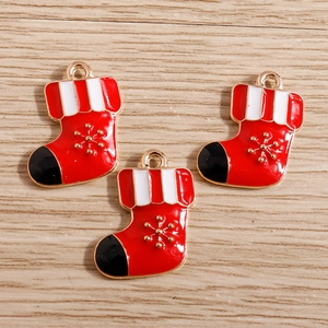 Detail of red enamel Christmas stocking charms with golden snowflake and hook