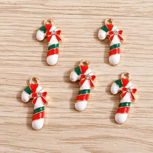 Detailed close-up of Christmas candy cane alloy pendants with red bows and rhinestones