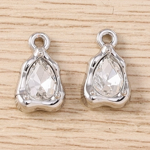 Detailed view of pear-cut crystal pendants with silver claw settings and top hanging loops