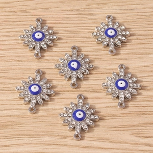 Detail of silver evil eye connectors with rhinestones for DIY jewelry making