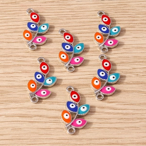 Detail of colorful leaf-shaped evil eye jewelry connectors for DIY bracelets and necklaces