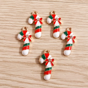 Detailed view of candy cane charms with red bows and sparkling crystals for DIY crafts