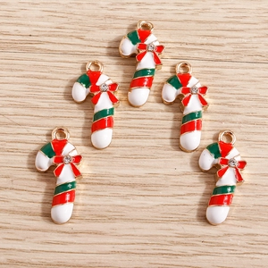 Detail of Christmas candy cane pendants with enamel stripes and rhinestone bow decorations