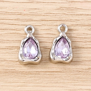 Detailed close-up of lavender teardrop gemstones set in textured silver metal frames