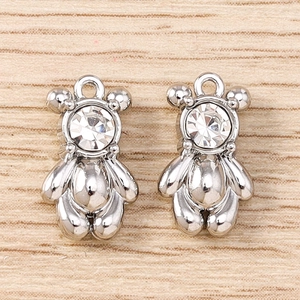 Detailed close-up of silver bear charms with clear rhinestones for DIY jewelry making