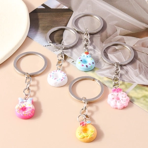 Set of five colorful resin donut keychains with sprinkles and cute bow decorations