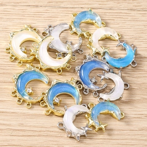 Macro shot of celestial crescent moon charms in gold and silver finish with star details