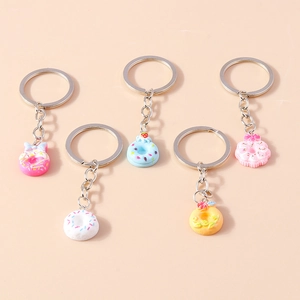 Set of five colorful resin donut keychains with floral and strawberry 3D details