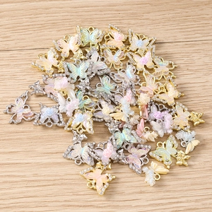 Detailed close-up of colorful rhinestone butterfly charms with rose accents for DIY jewelry