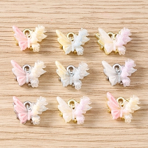 Detailed close-up of colorful rhinestone butterfly charms with metal loops for jewelry making
