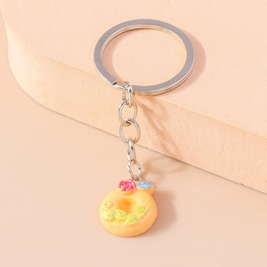 Detailed macro view of creative resin donut keychain with pink rose floral decoration