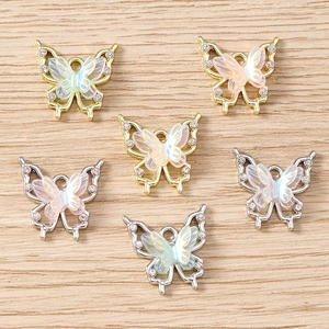 Macro detail of rhinestone butterfly pendants with iridescent resin for DIY jewelry making