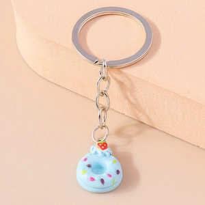 Close-up of light blue resin donut keychain with colorful sprinkles and silver chain