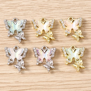 Macro detail of layered rhinestone butterfly charms for jewelry making in gold and silver