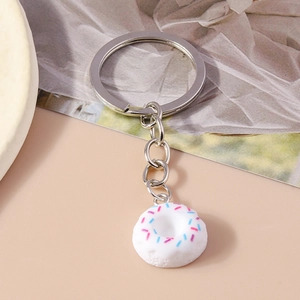 Detail of creative donut keychain with blue and pink sprinkles and silver metal ring