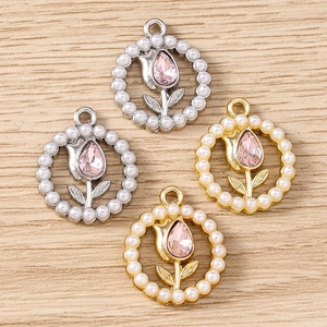 Macro shot of tulip flower charms with pink teardrop crystal and pearl beads