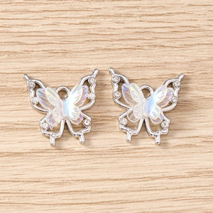 Macro detail of rhinestone butterfly pendant with iridescent wings for DIY jewelry making