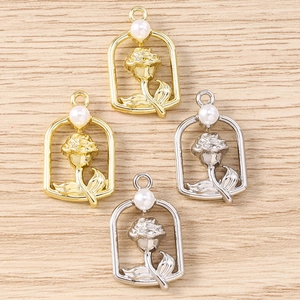 Detailed view of rose flower pendants with faux pearls for DIY jewelry making
