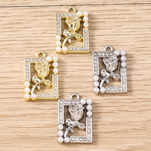 Detailed macro view of rhinestone flower pendants with pearls in gold and silver finish