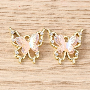 Close-up of iridescent butterfly pendants with rhinestones and gold metal finish