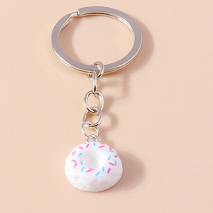 Detailed view of creative donut keychain with silver ring and colorful sprinkles