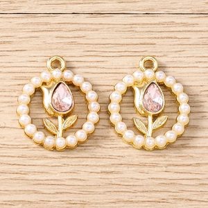 Macro detail of tulip flower pendants with pink rhinestones and pearl border for DIY jewelry