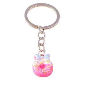 Creative realistic donut keychain with pink frosting, blue bow and colorful sprinkles decor