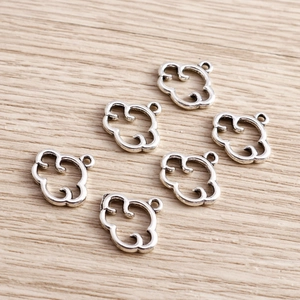 Macro shot of silver hollow cloud-shaped alloy charms for DIY jewelry making
