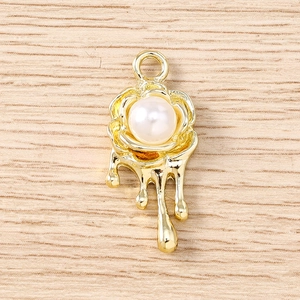 Close-up of gold rose pearl pendant with fluid lava drop effect for DIY jewelry making