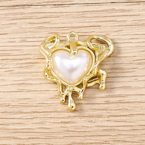 Detailed view of heart-shaped pearl pendant with liquid gold lava style frame