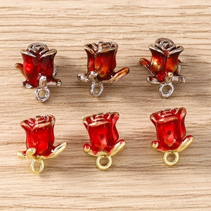Macro detail of red rose flower charms in gold and silver plating for DIY jewelry making