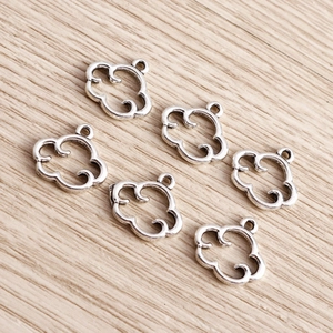 Detailed close-up of hollow cloud charms in antique silver alloy finish for DIY jewelry making